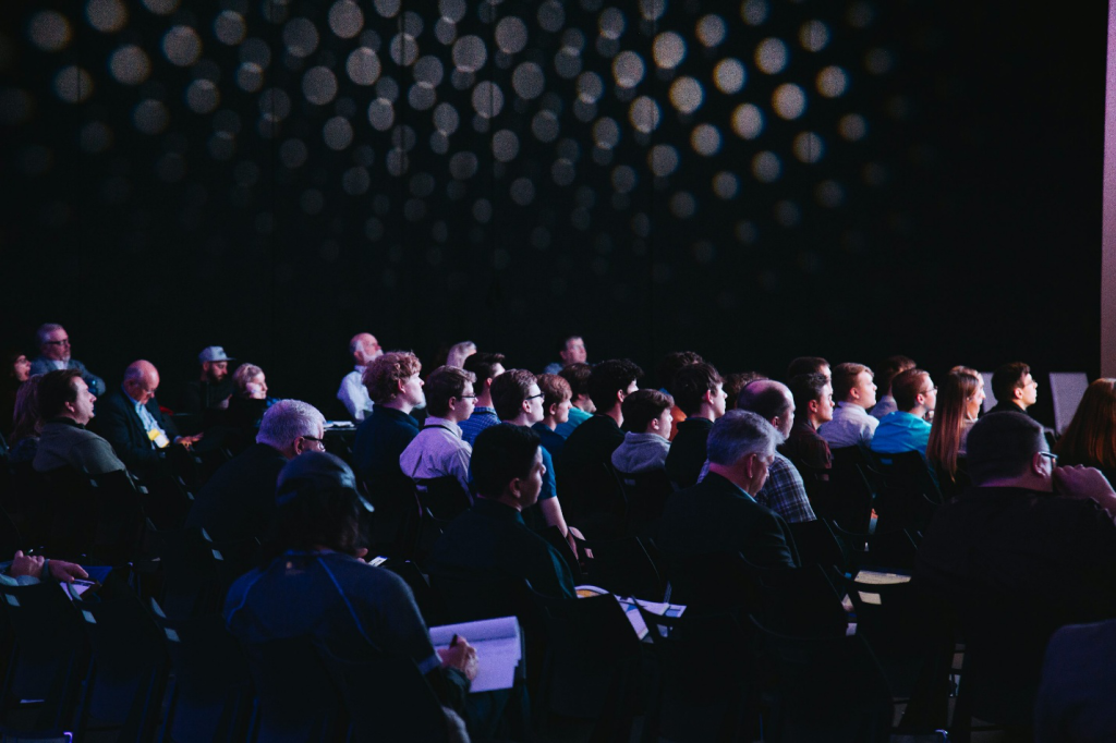 A corporate event with people sitting in chairs