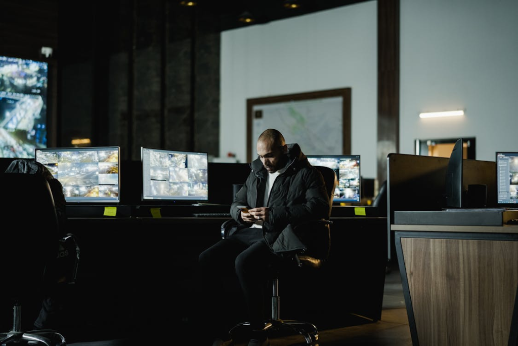 Security professionals monitoring multiple CCTV screens in a control room