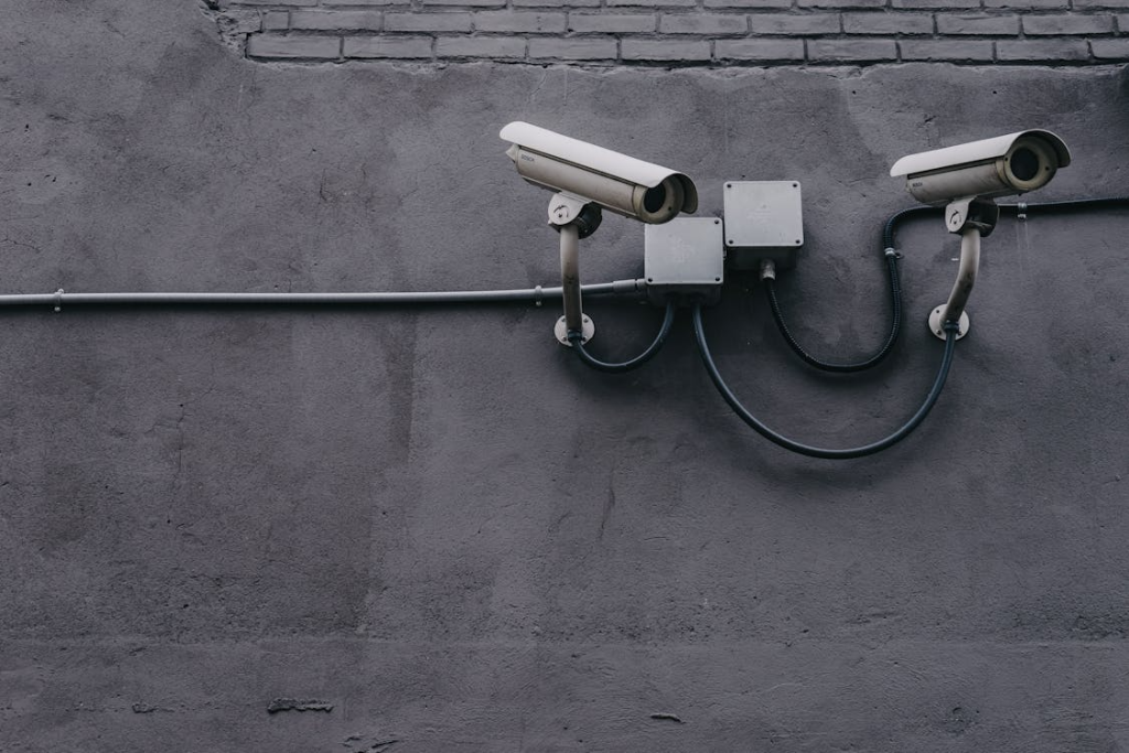 closeup of CCTV cameras on a gray wall for security