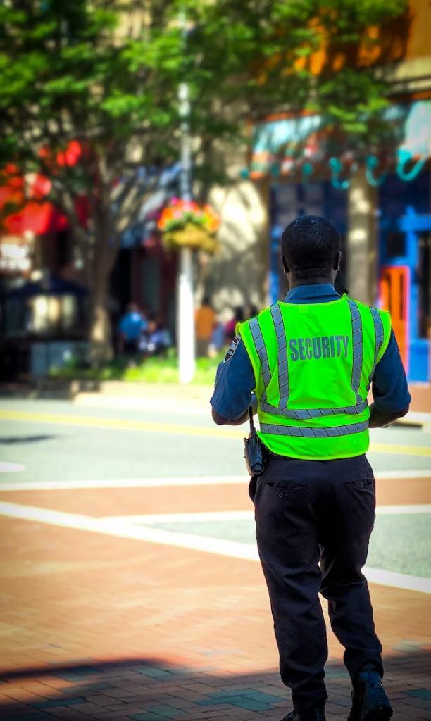 a guard wearing a security jacket walking