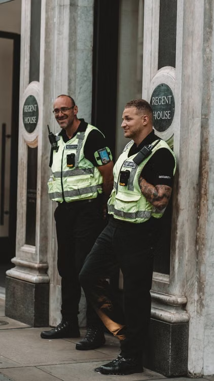 security guards standing outside a building.