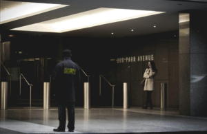 a security guard standing by a building’s entrance