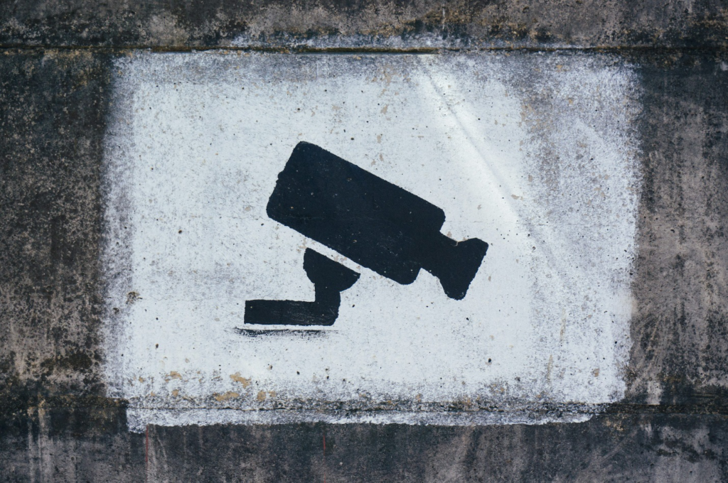 A sign on a wall of CCTV cameras